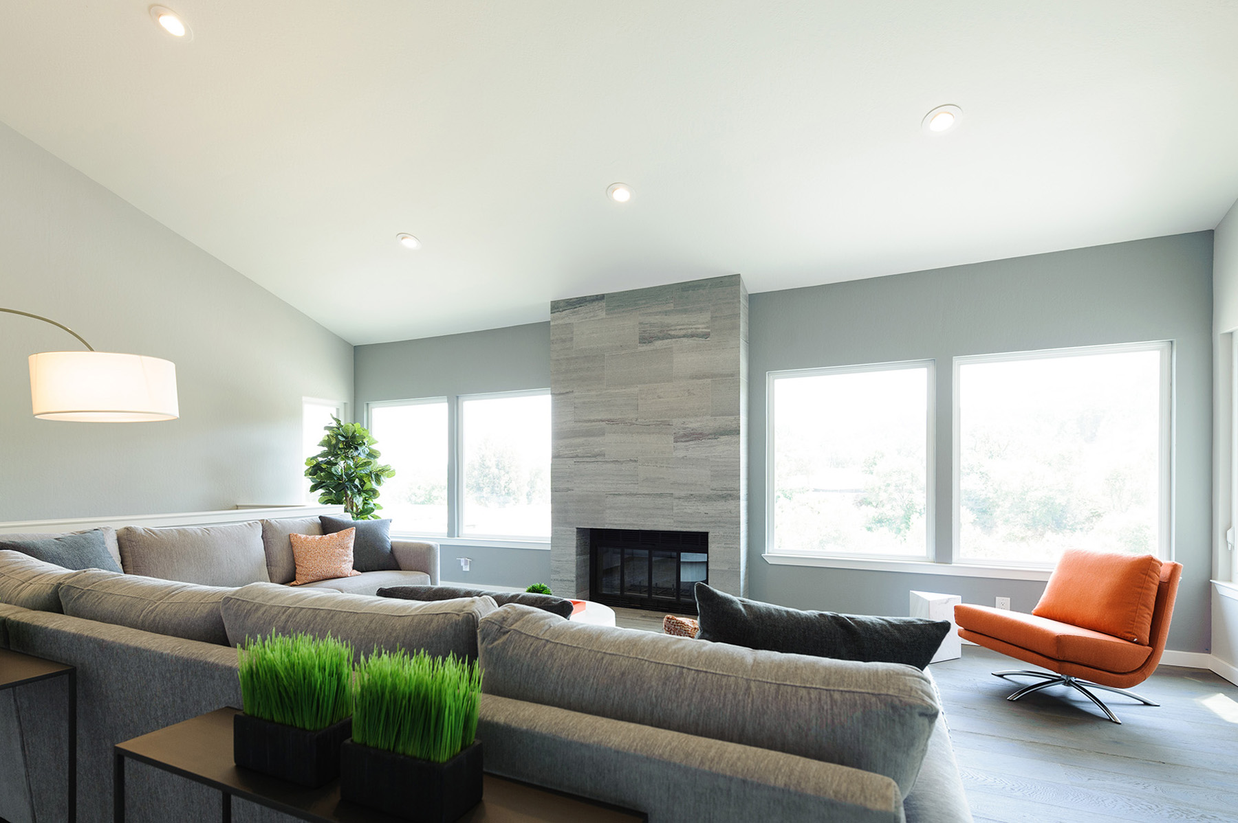 Lafayette hillside home family room with stone fireplace and large windows